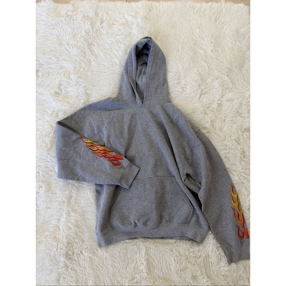 Silence + Noise’s L gray hoodie features flames on its sleeves in red and orange